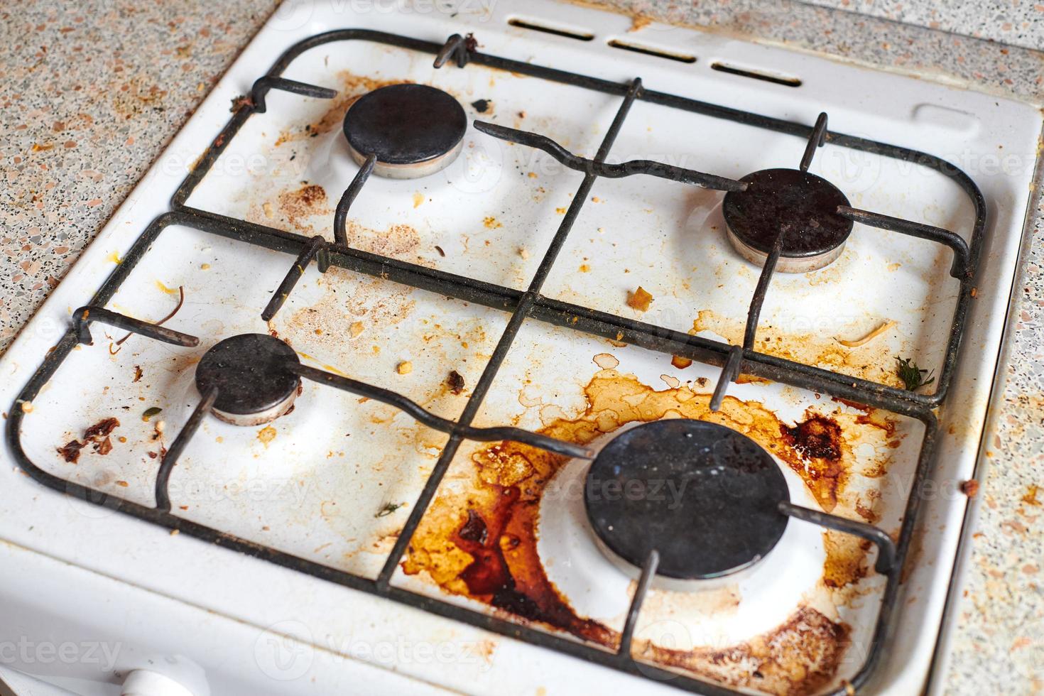 Dirty stove with food leftovers photo