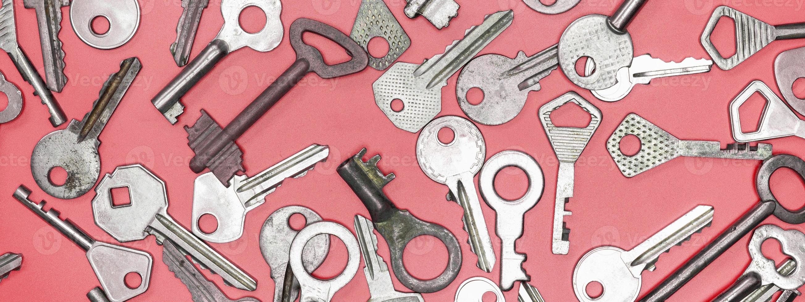 Keys set on pink background. Door lock keys and safes for proper photo