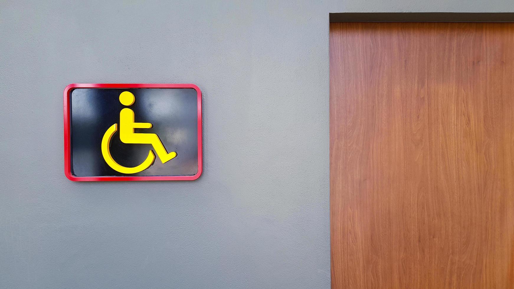 Toilet sign on gray or grey wall for reserved disable people use this washroom only with copy space. Public restroom or Cripple on wheel chair. Design and Shape of object. photo