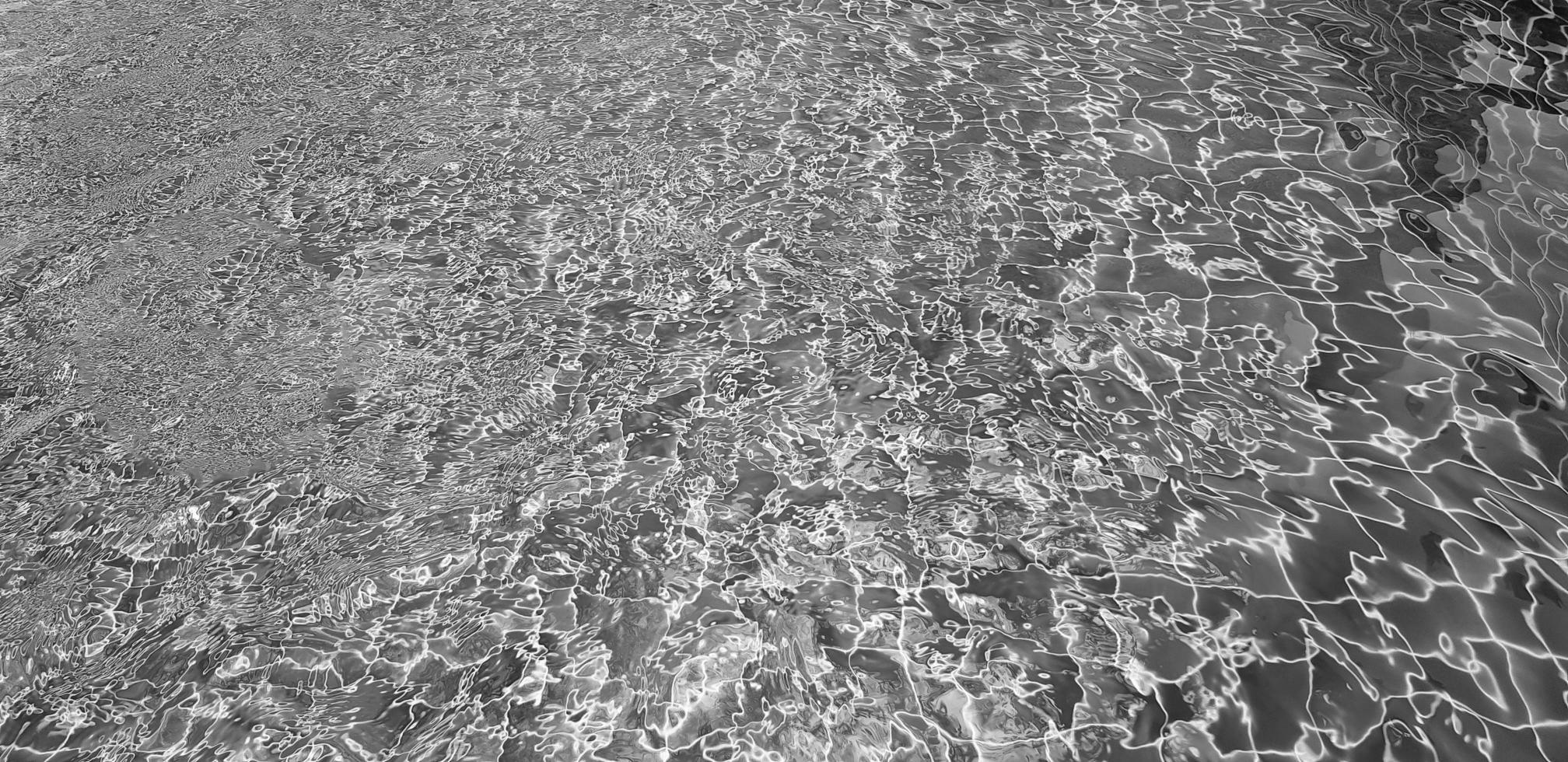Art of swimming pool background in black and white. Abstract wave on water and reflection wallpaper in monochrome style. photo