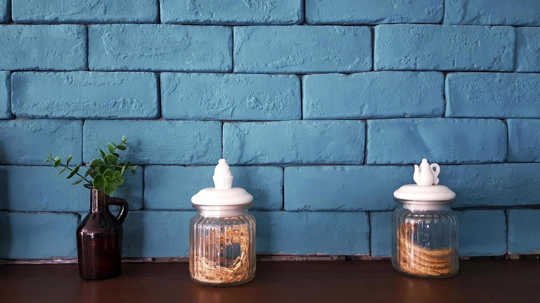 Glass bottle or jug with flower dry inside and brown glass bottle and