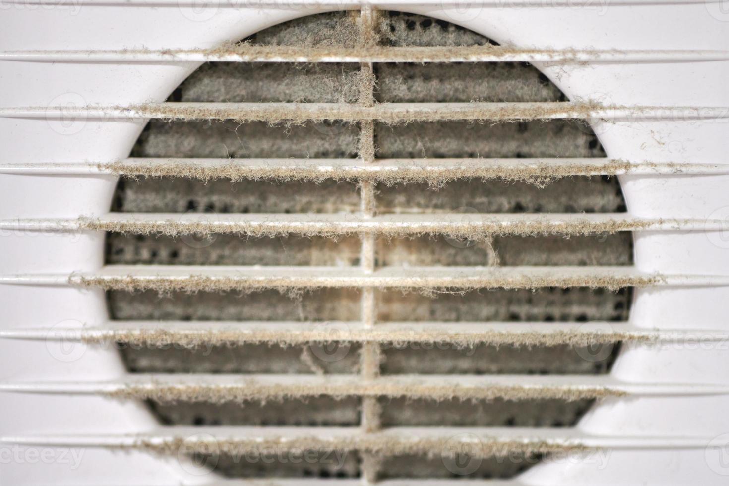 Dirty air ventilation grill of HVAC with clogged filter. photo