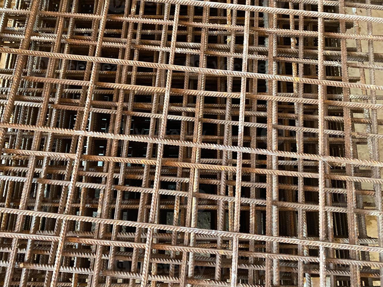 Iron rusty bars of wire reinforcement for building houses and producing industrial reinforced concrete at a construction site photo