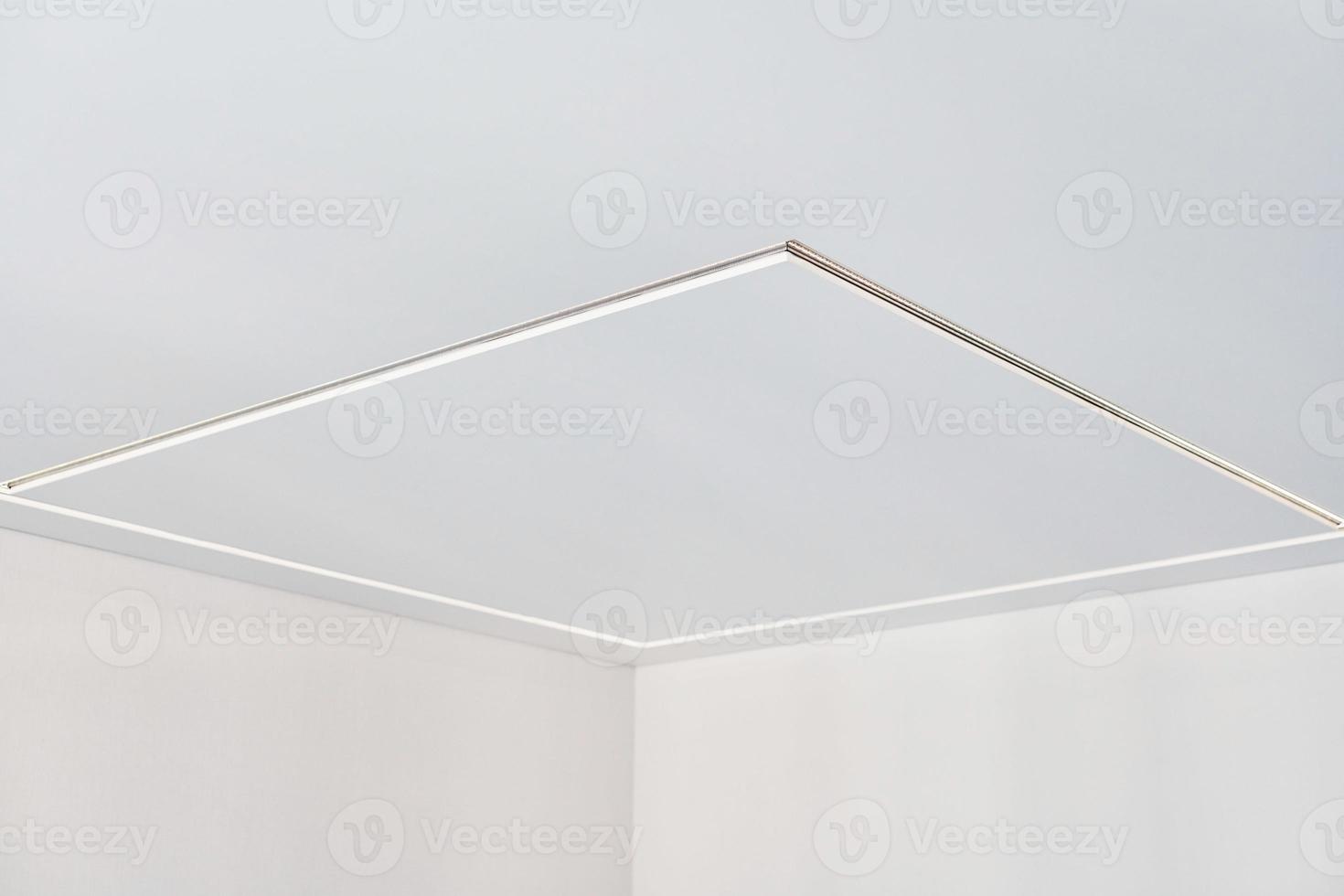 Suspended ceiling with LED strip lamp in empty room, repair photo