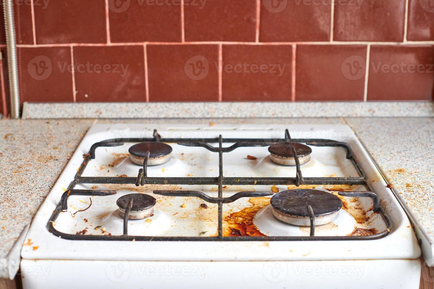 Dirty stove with food leftovers photo