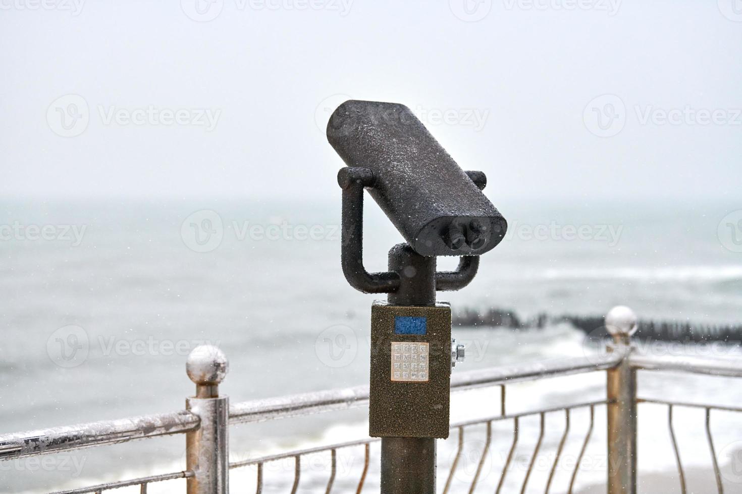 Coin-operated binocular viewer looking out to sea photo