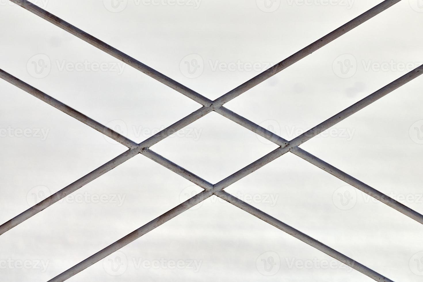 Metal fence with rhombus ornament on grey background photo