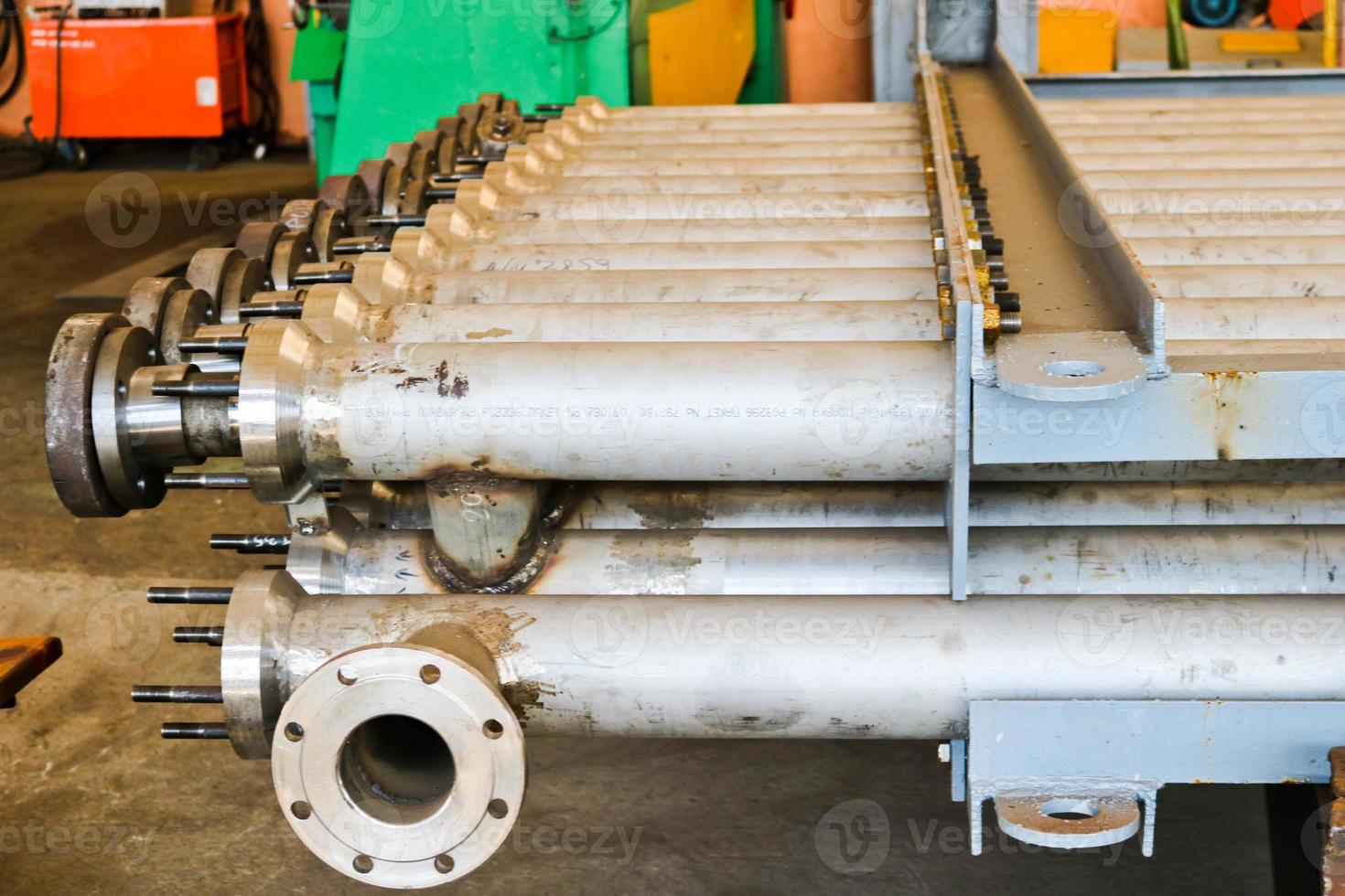 Warehouse, storage of metal iron long stainless pipes with flanges, passages and branches at the petrochemical, metallurgical industrial plant plant photo