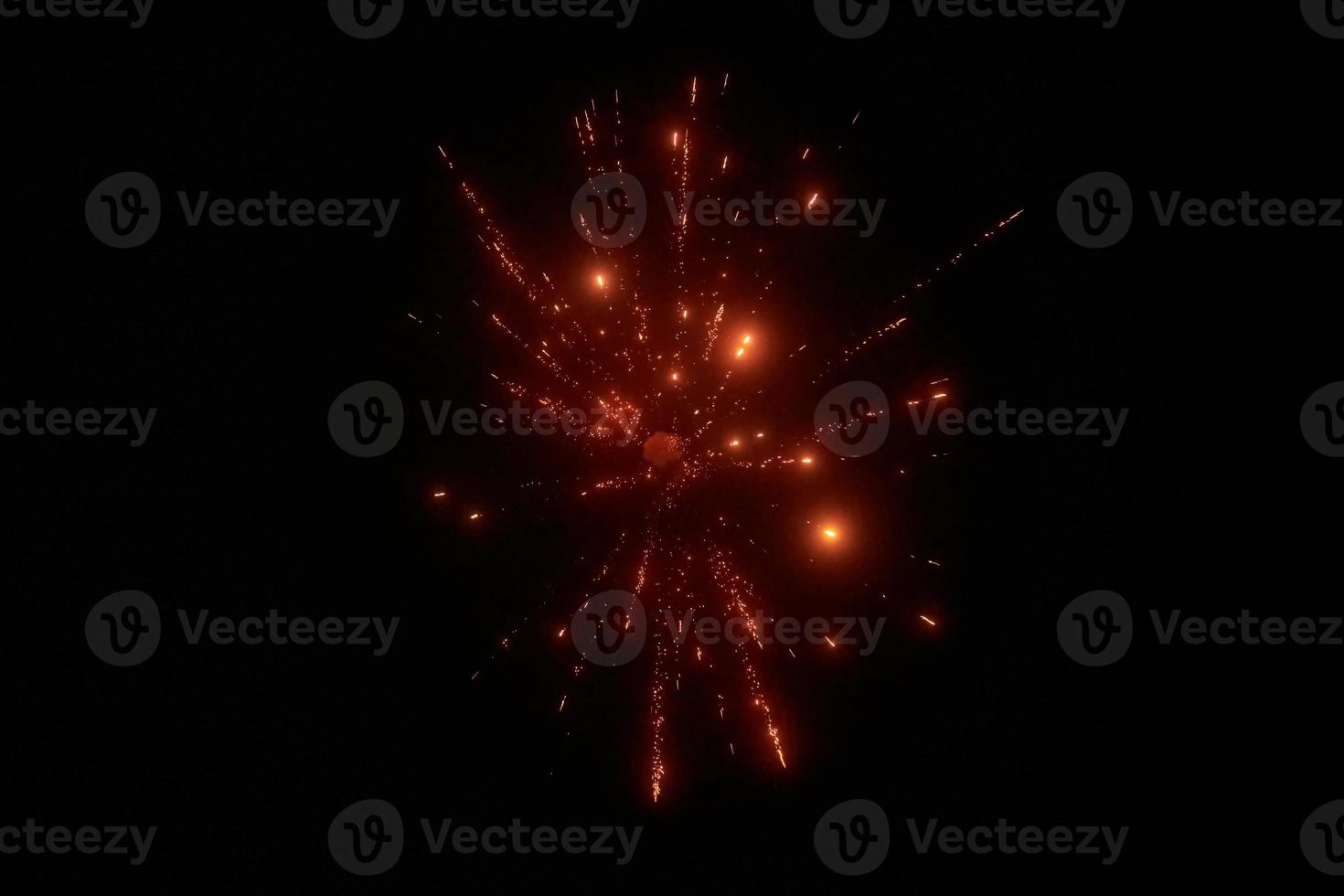 Red night fireworks bright sparkles and shiny festival explosion, glittering motion of sky fire photo