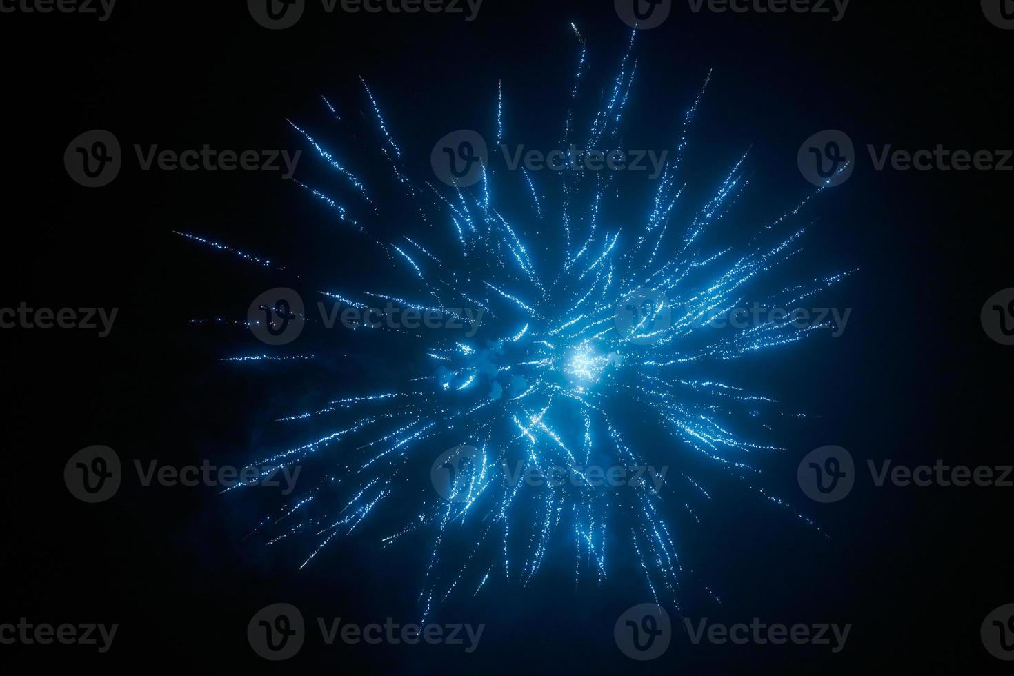 Blue night fireworks colorful bright sparkles and shiny festival explosion, glittering of sky fire photo