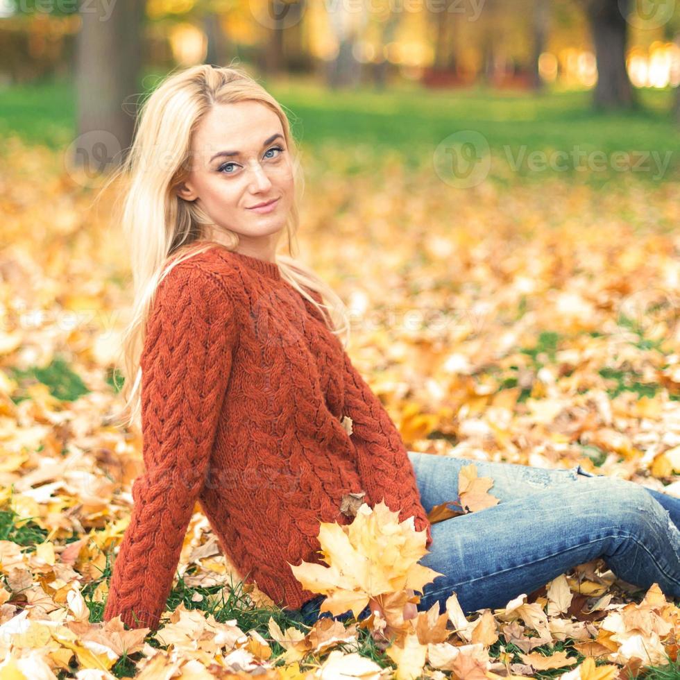 Young woman in park on autumn day photo