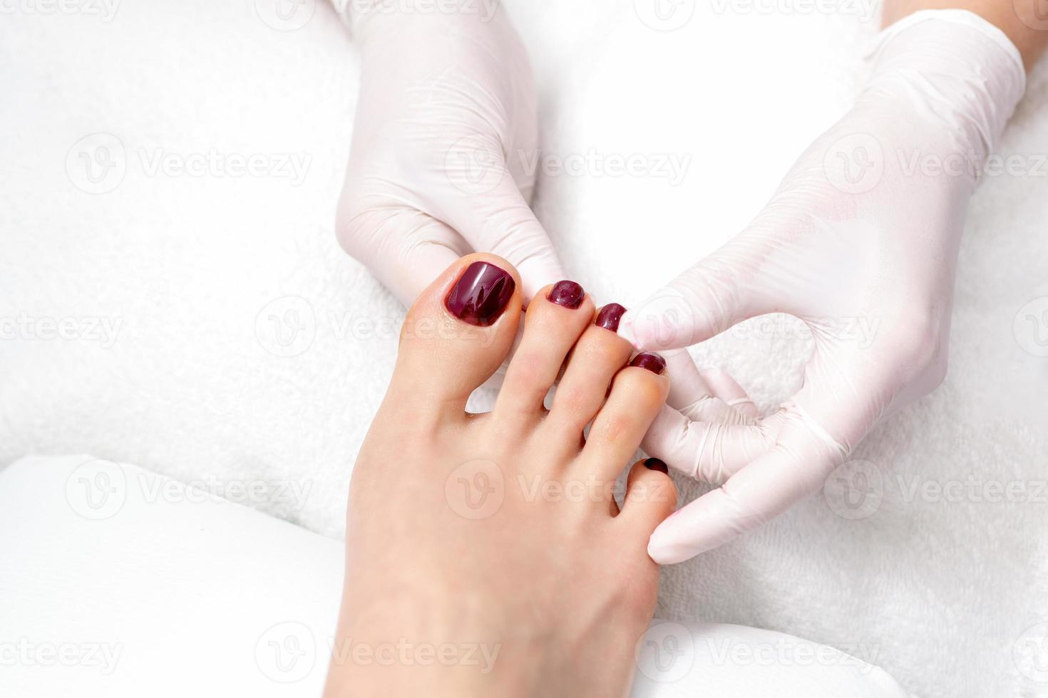 human hands holding painted toenails photo
