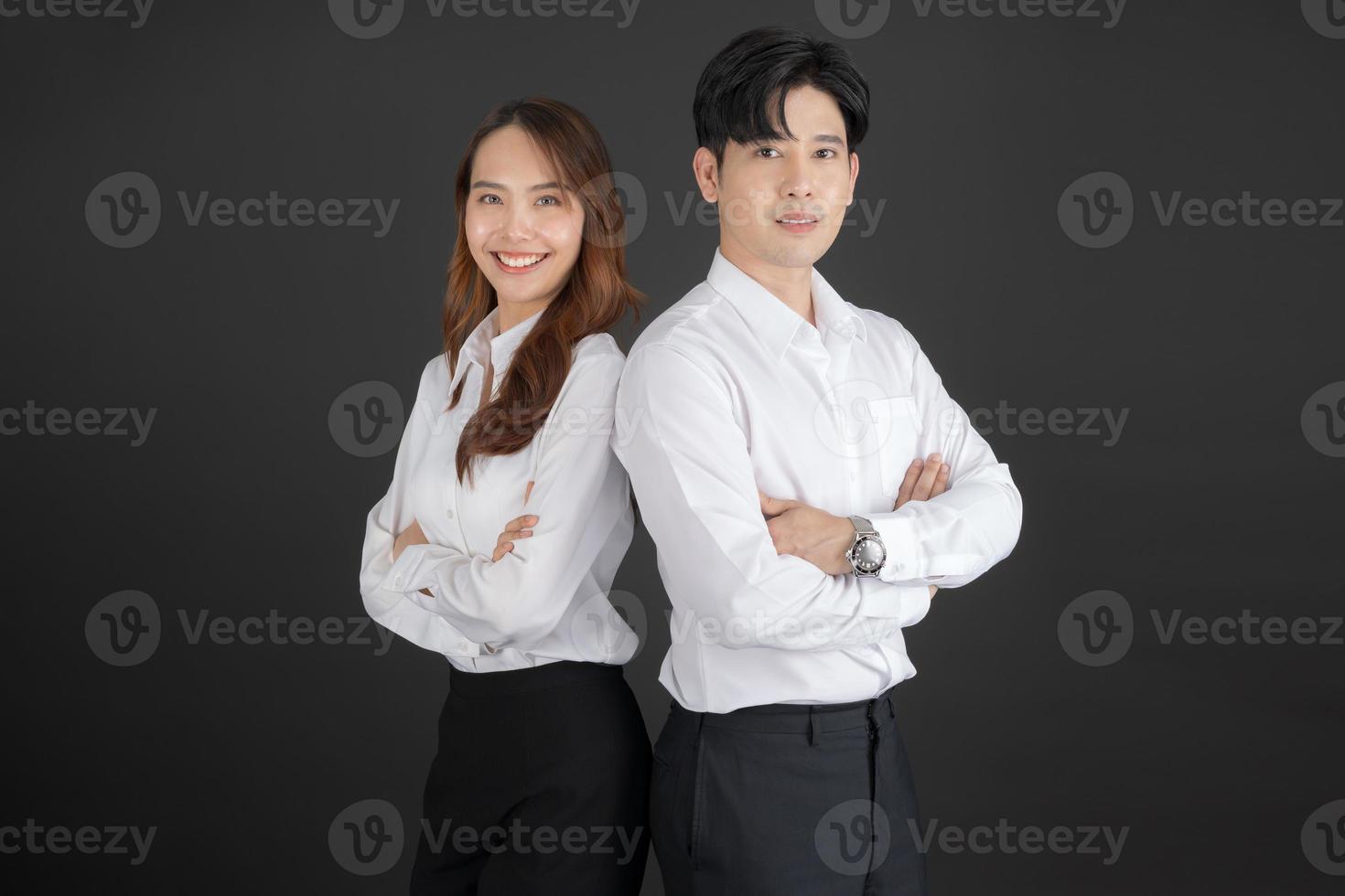 Two young businessmen standing with their arms crossed. photo