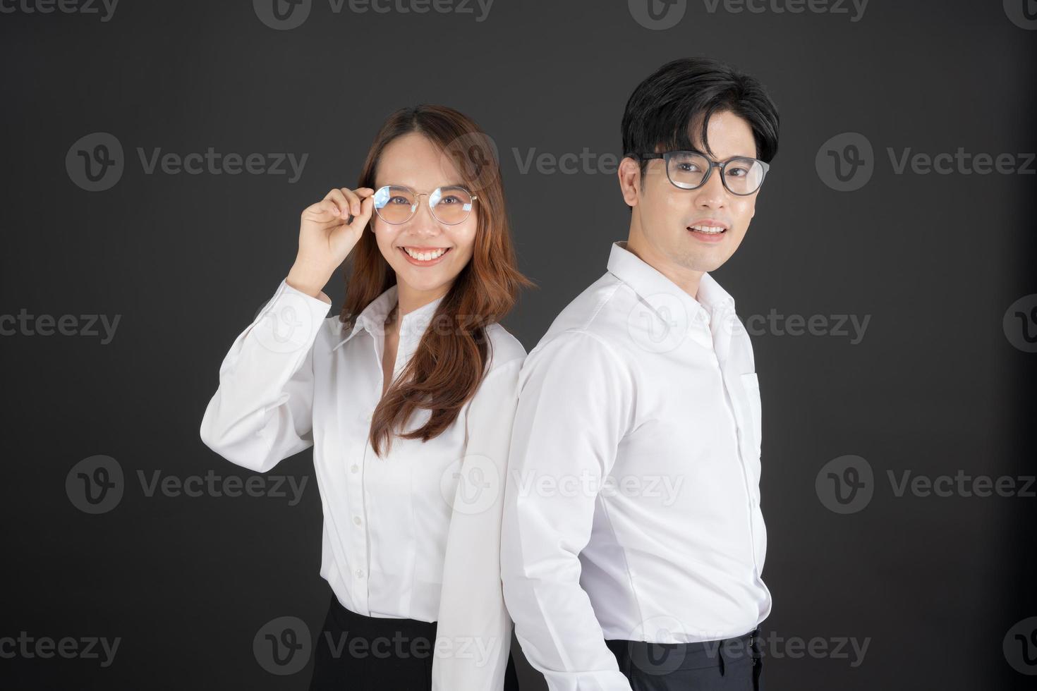 Two young businessmen standing with their arms crossed. photo