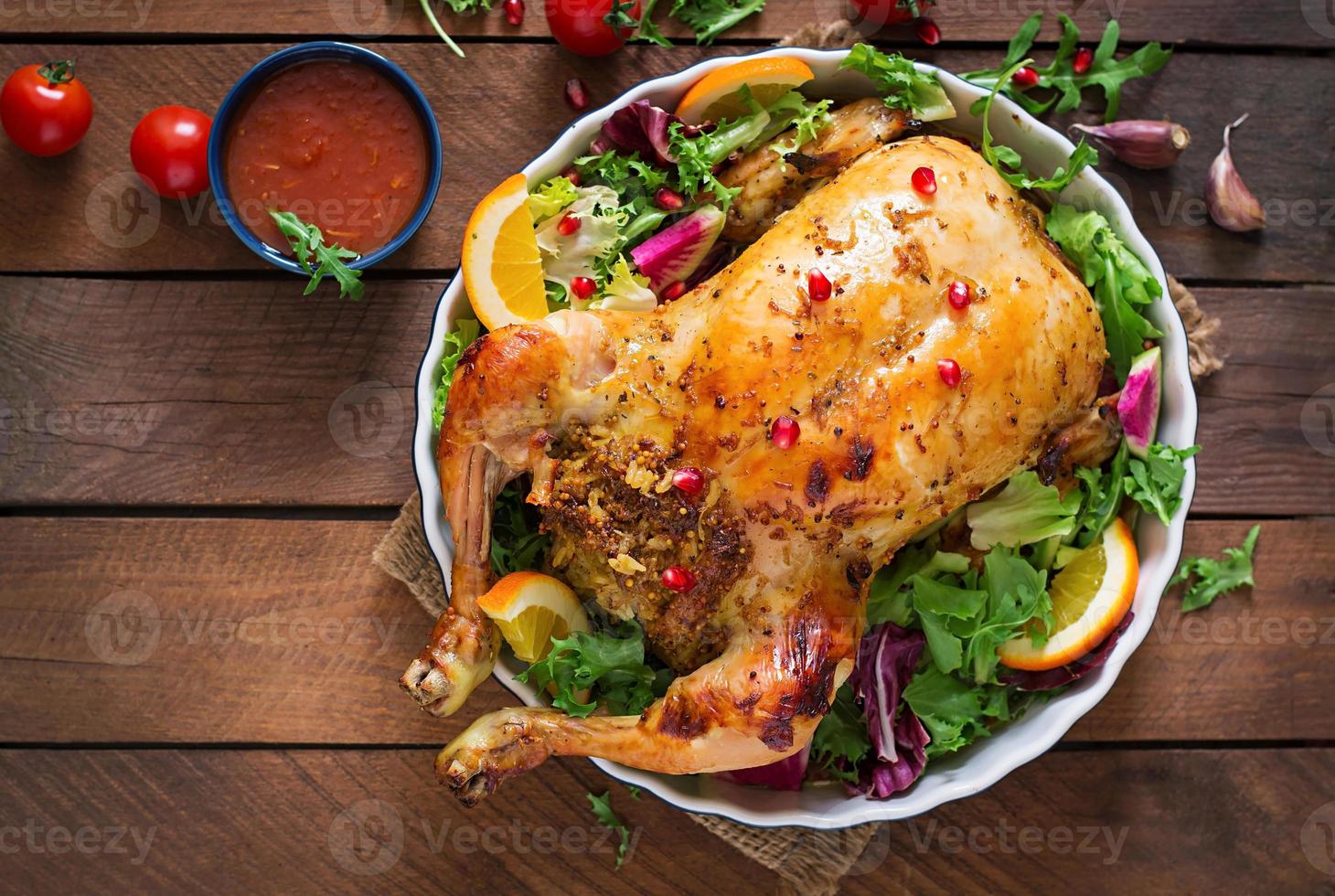 Baked chicken stuffed with rice for Christmas dinner on a festive table photo