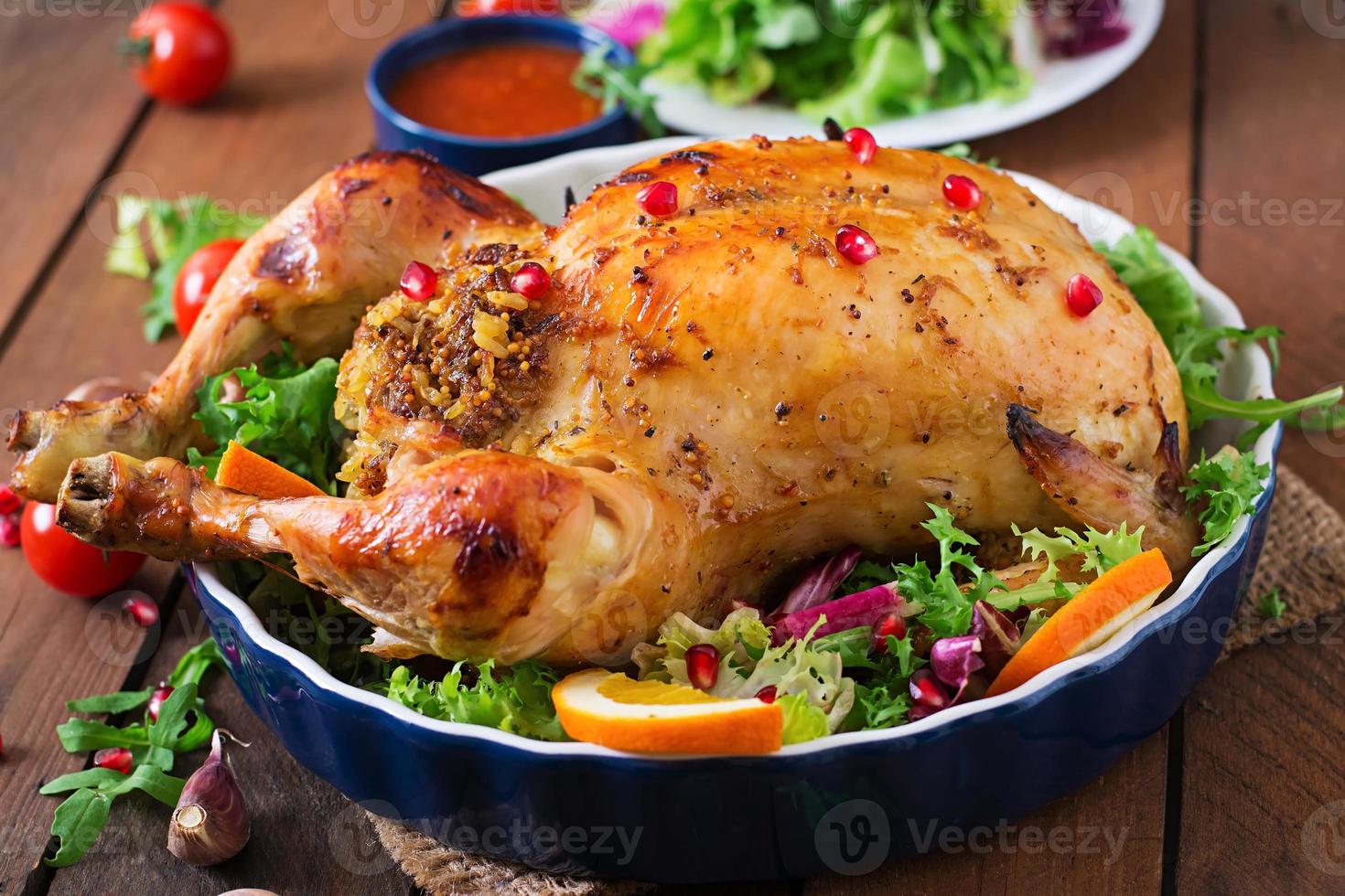 Baked chicken stuffed with rice for Christmas dinner on a festive table photo