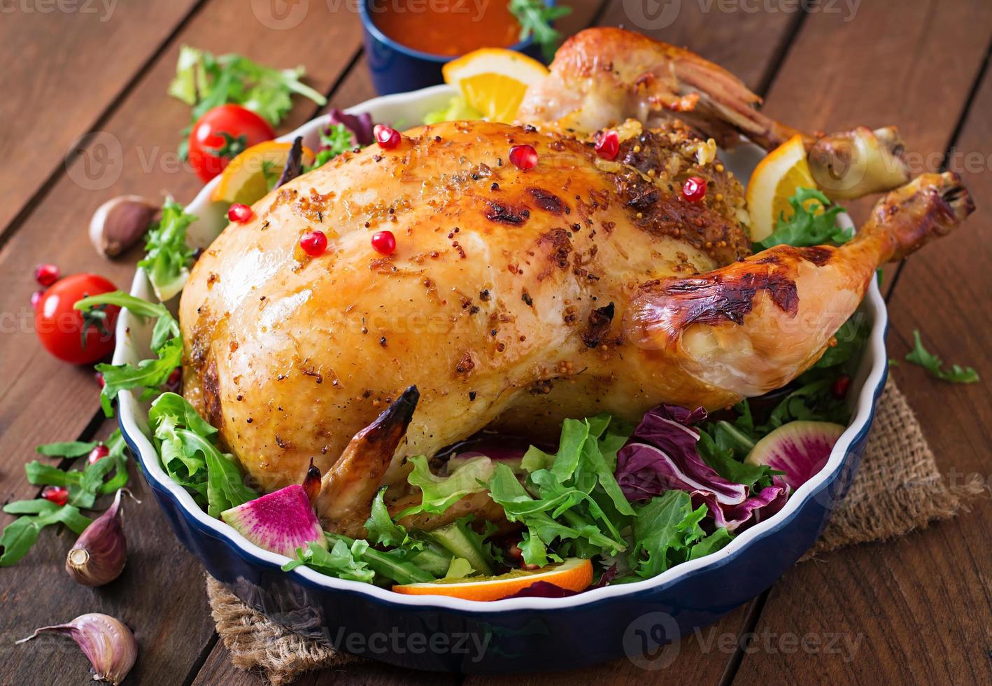 Baked chicken stuffed with rice for Christmas dinner on a festive table photo