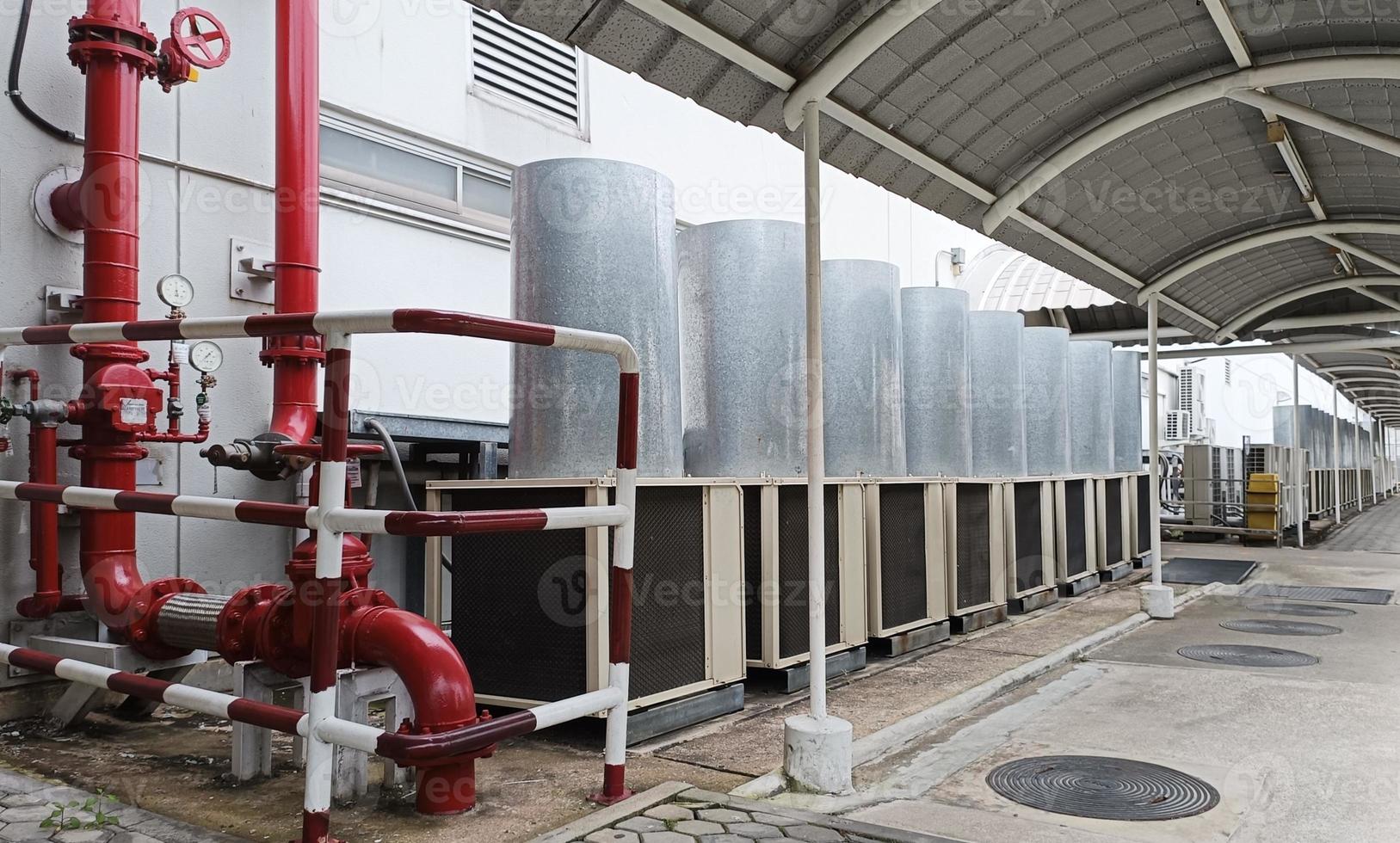 Horizontal photo of pipes and large air conditioners in industrial zones