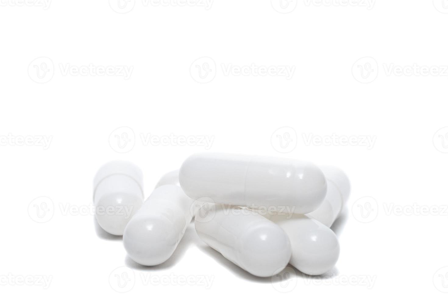 white pills an pill bottle on white background photo