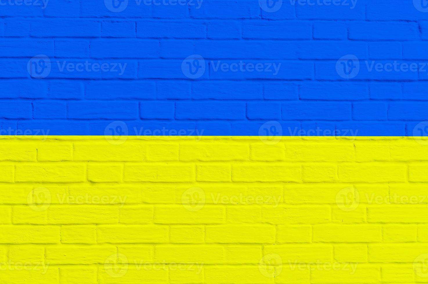 National flag of Ukraine on brick wall background photo