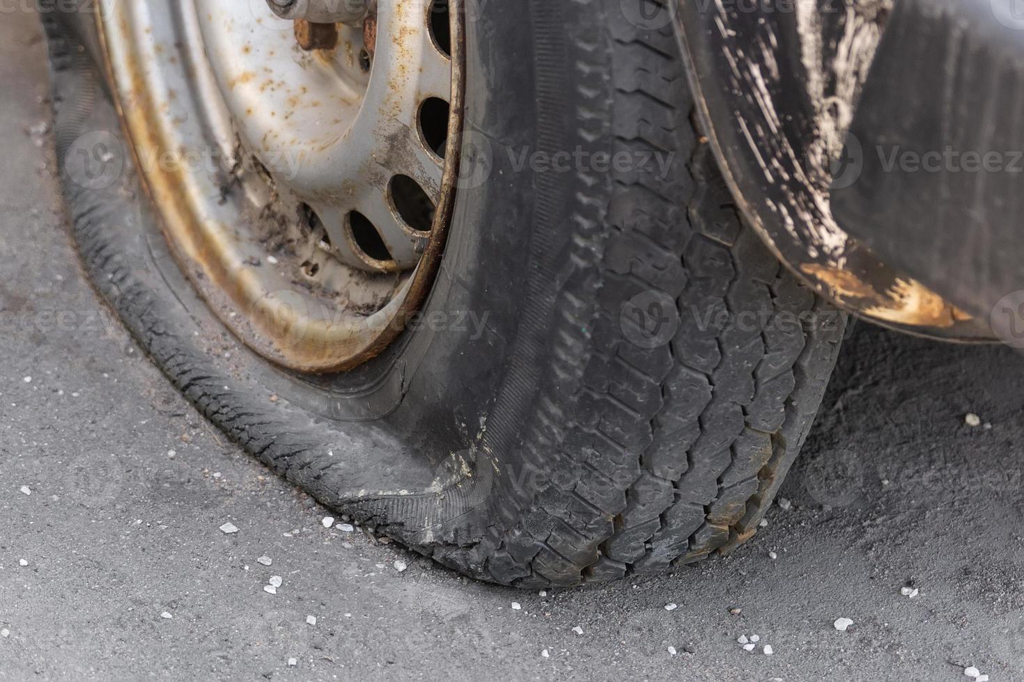 Closeup car flat tire on the road. photo
