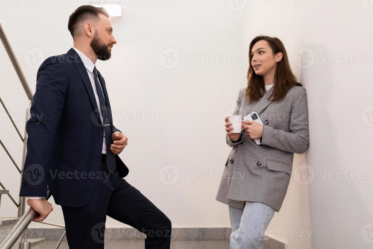 informal communication of colleagues at lunch break on the landing of the office photo