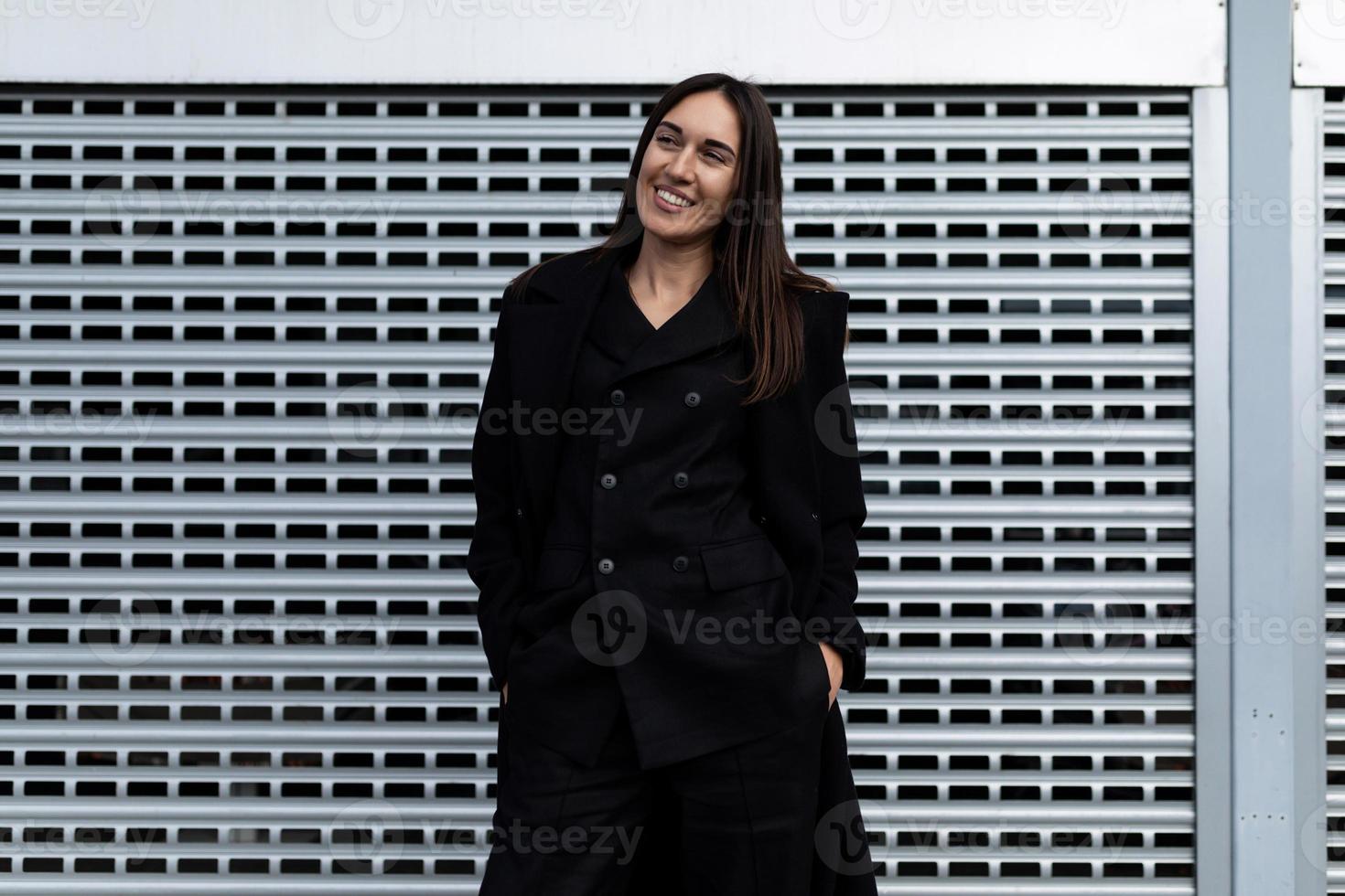 forty-year-old successful business women with a wide smile against the background of aluminum blinds photo
