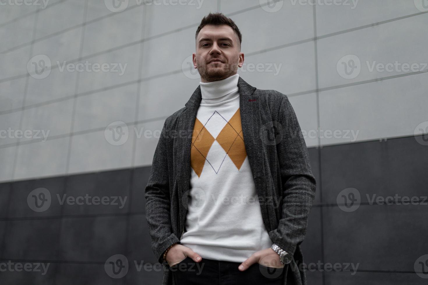 portrait of a brutal young man against a black and white wall photo