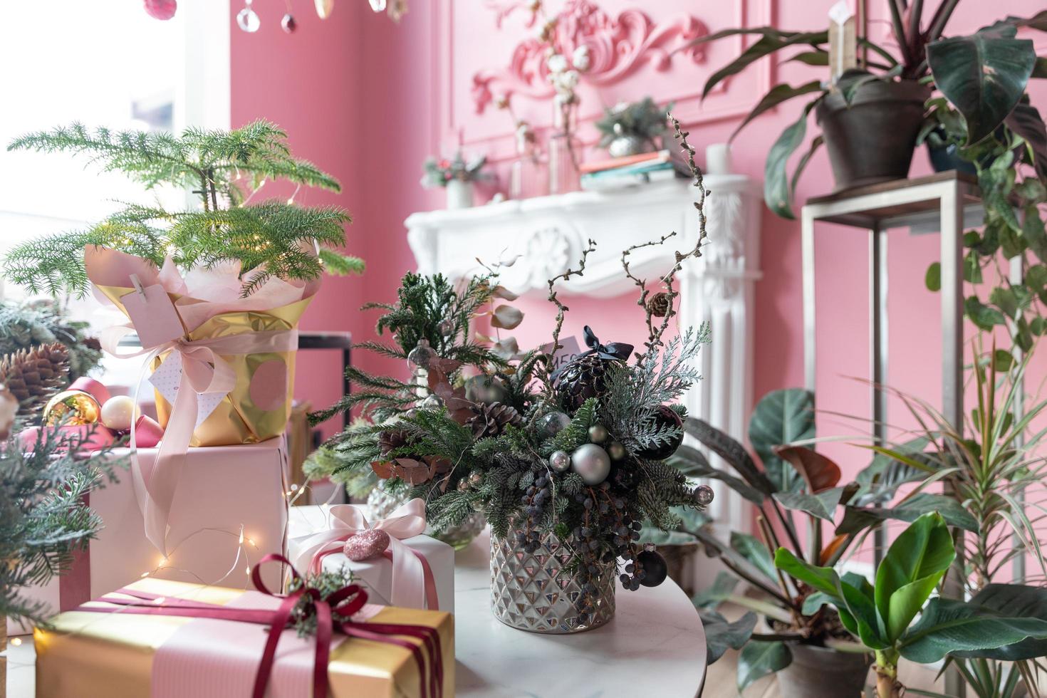 stylish New Year's compositions from natural fir needles in the foreground in a stylish pink interior photo