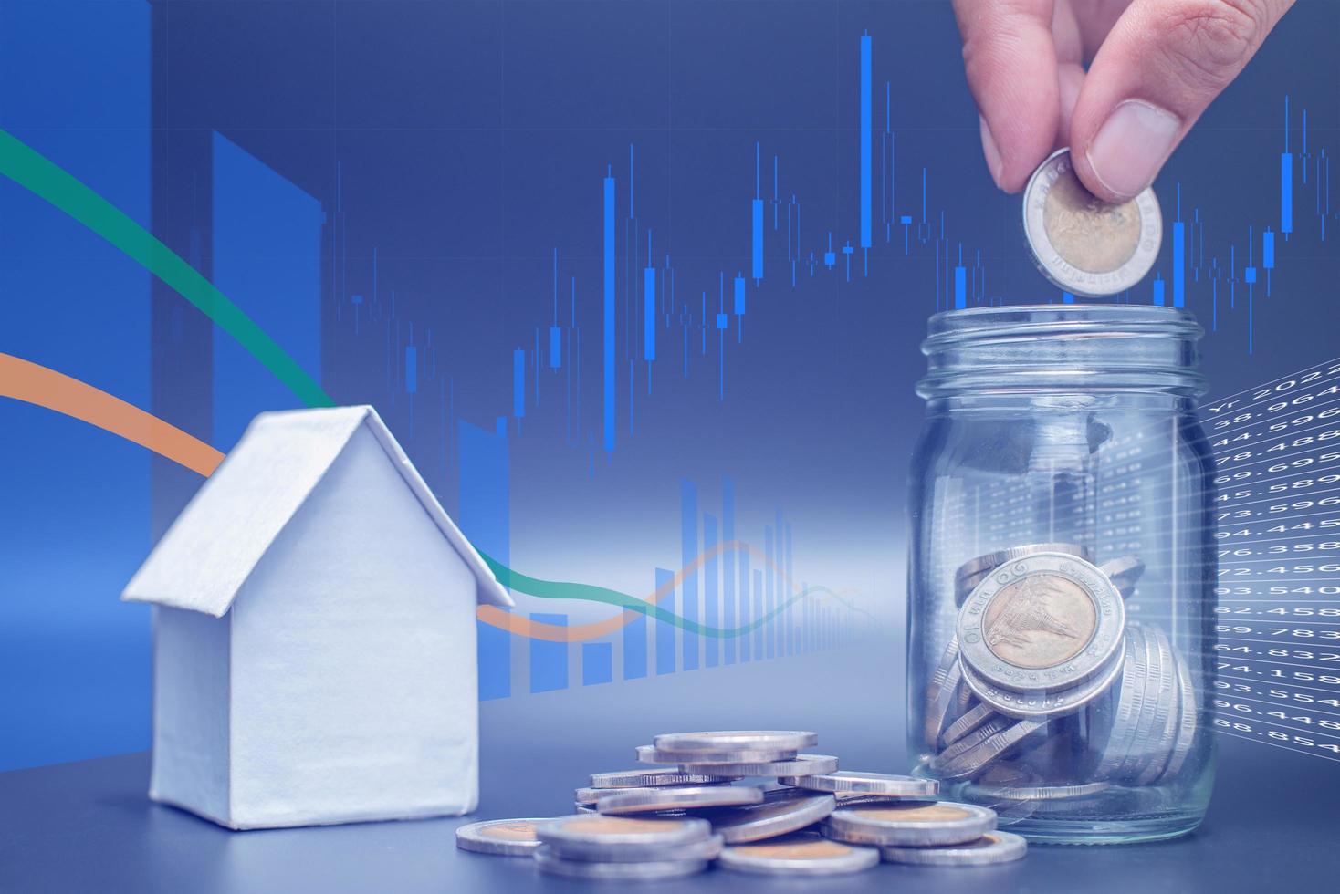 Double exposure of Thailand coins on black background with jar, house model and profit graph photo
