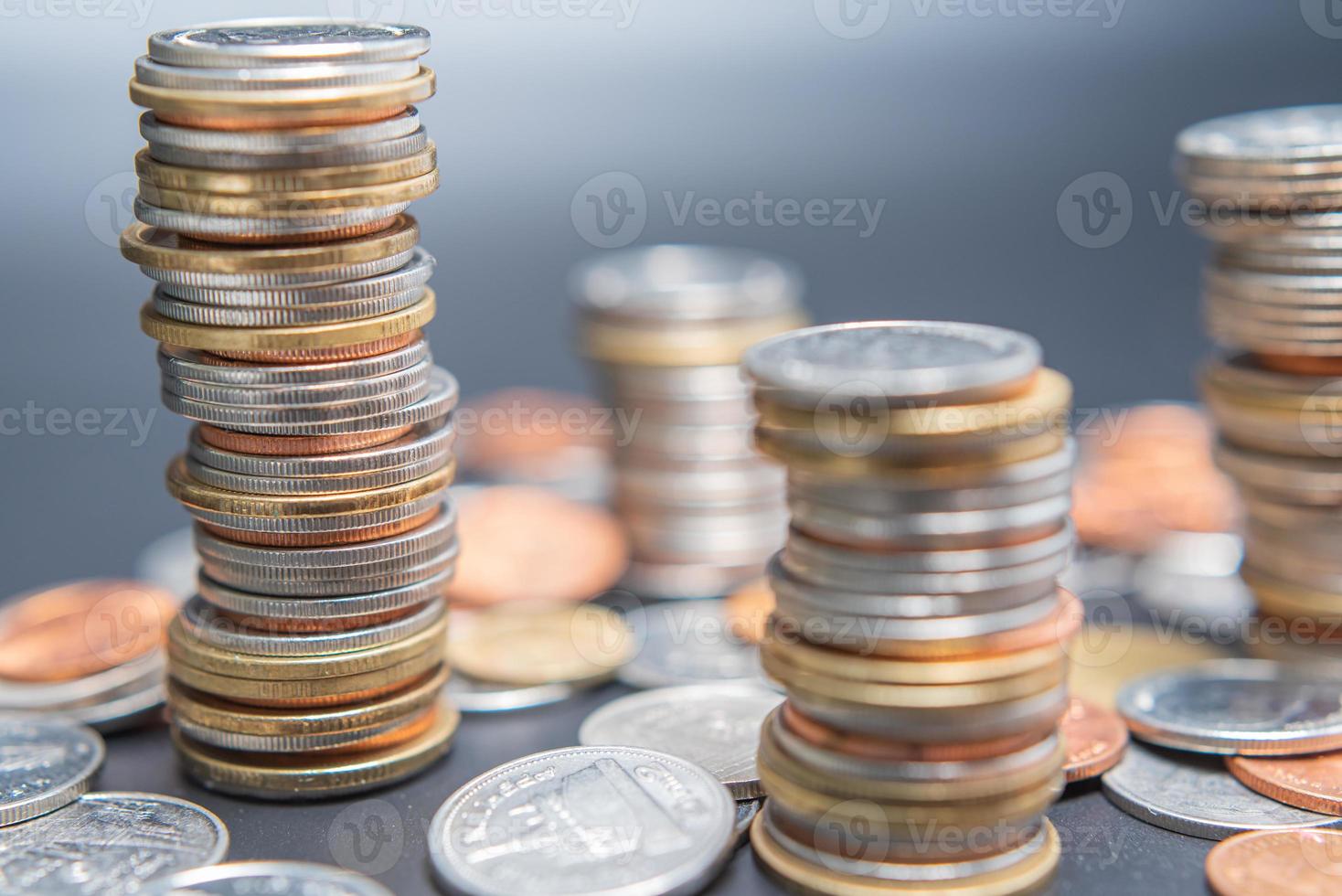 Stack of coins and heap coins on black table. photo