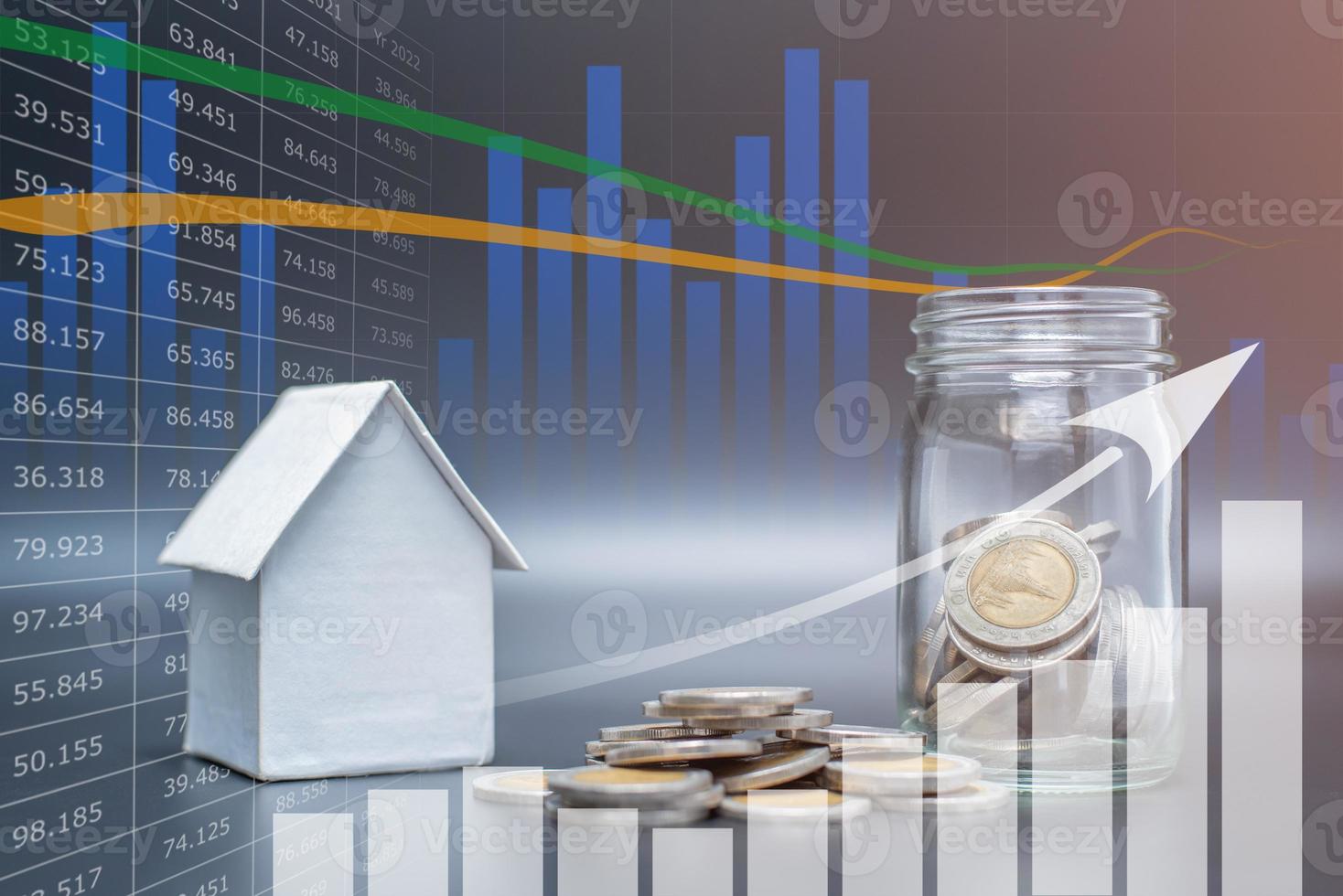 Double exposure of Thailand coins on black background with jar, house model and profit graph photo