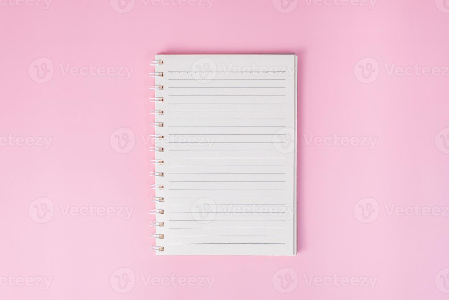 Top view image of notebook on pink background photo