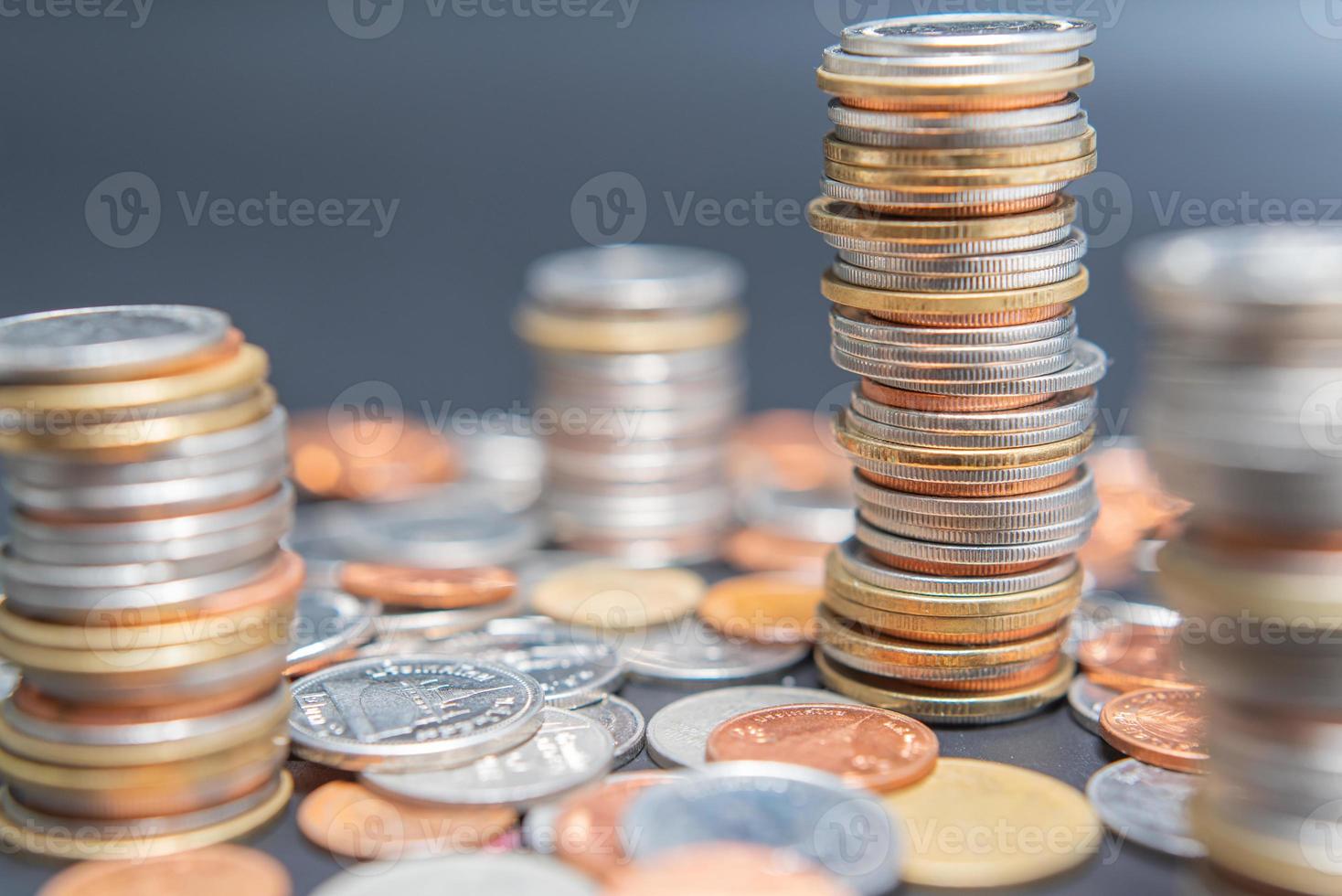 Stack of coins and heap coins on black table. photo