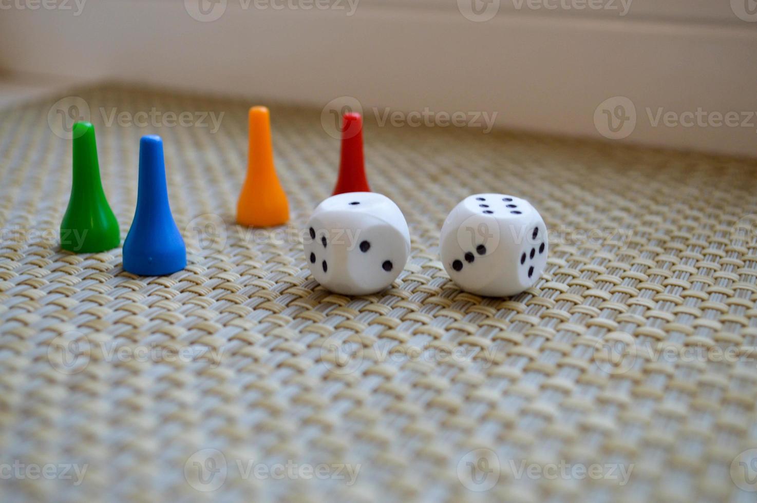 White dice and four chips for board games. photo