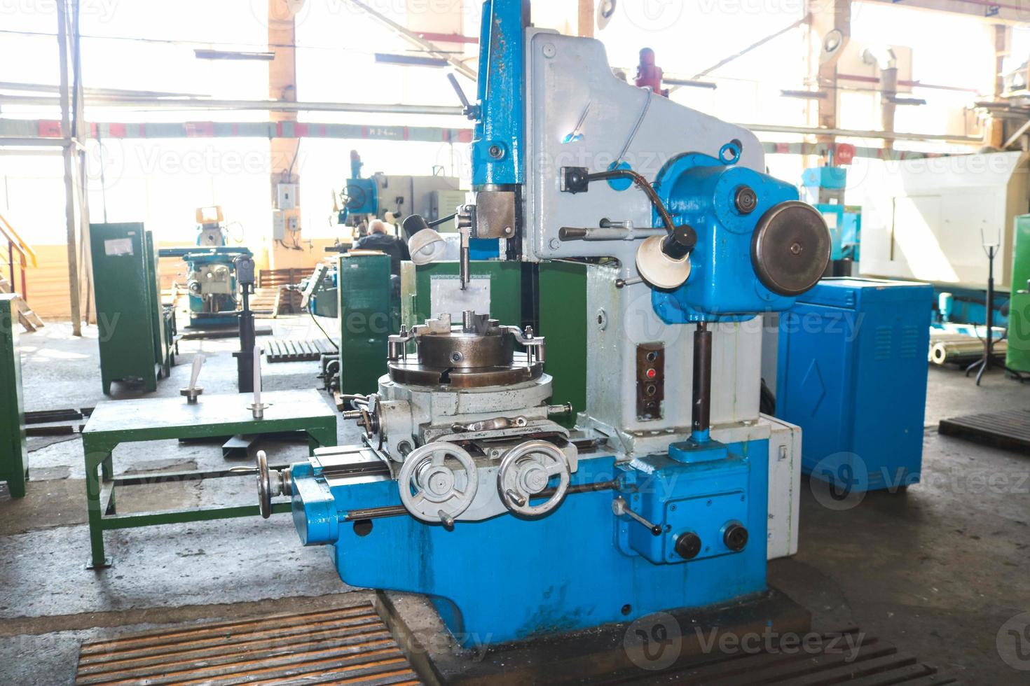 Industrial iron lathe for cutting, turning of billets from metals, wood and other materials, turning, manufacturing of details and spare parts at the factory photo