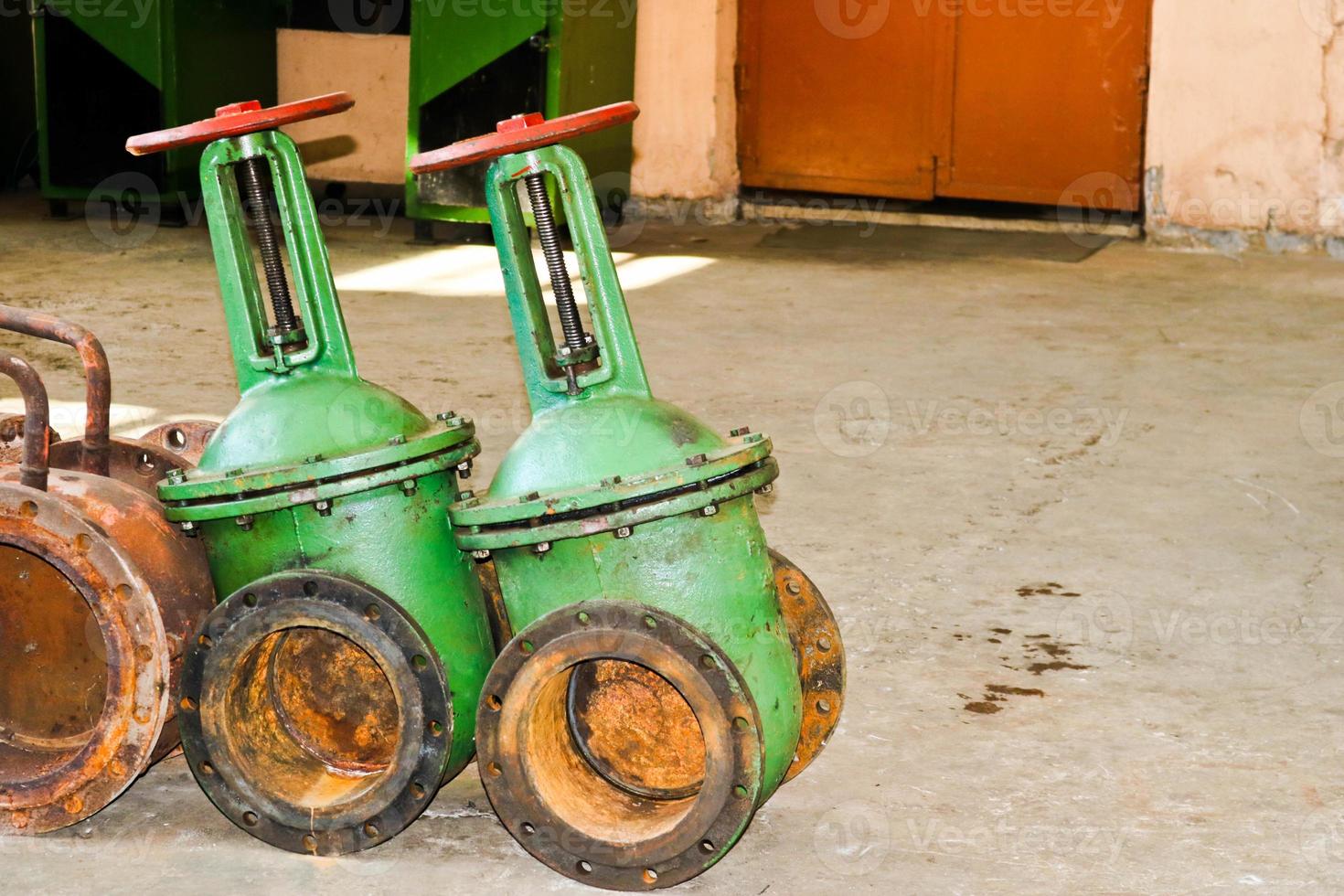 Two large iron metal pipeline valves with flanges, wedge gate valves at an oil refinery, petrochemical, chemical industrial plant, enterprise photo