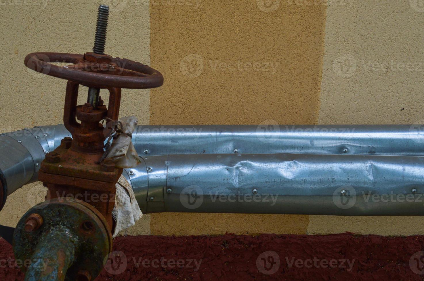 Iron old rusty corrosion-proof industrial metal pipes with flanges valves transitions and branches for the oil and gas petrochemical industry photo