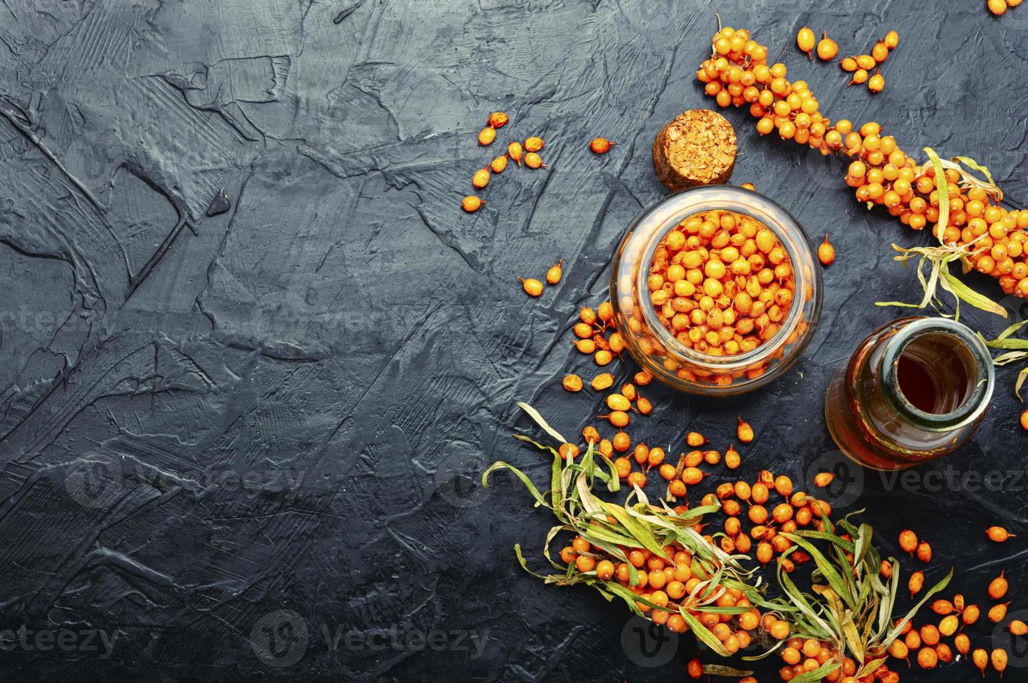 Sea buckthorn berries in herbal medicine photo