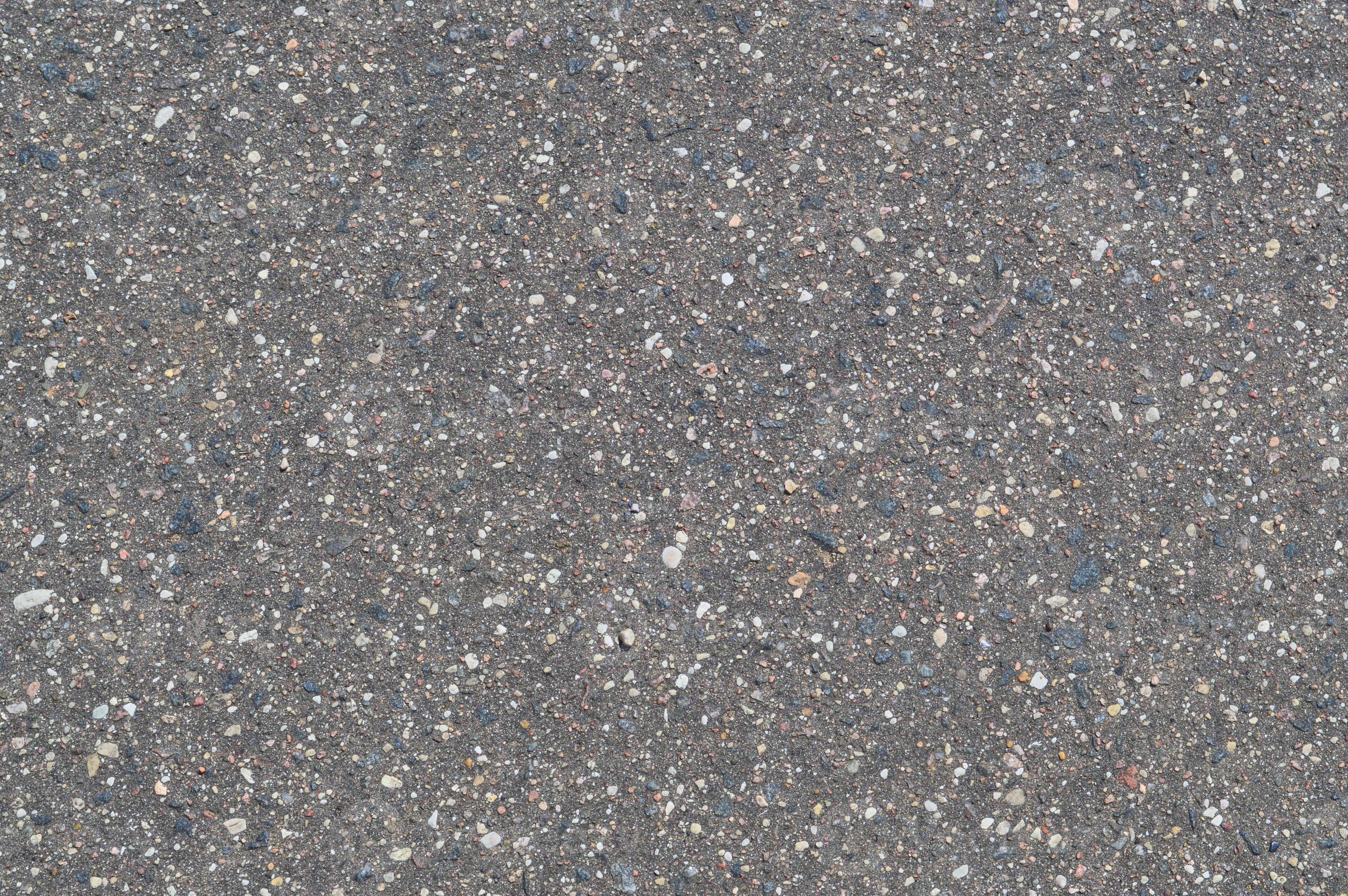 The texture of the background of stone black gray asphalt road