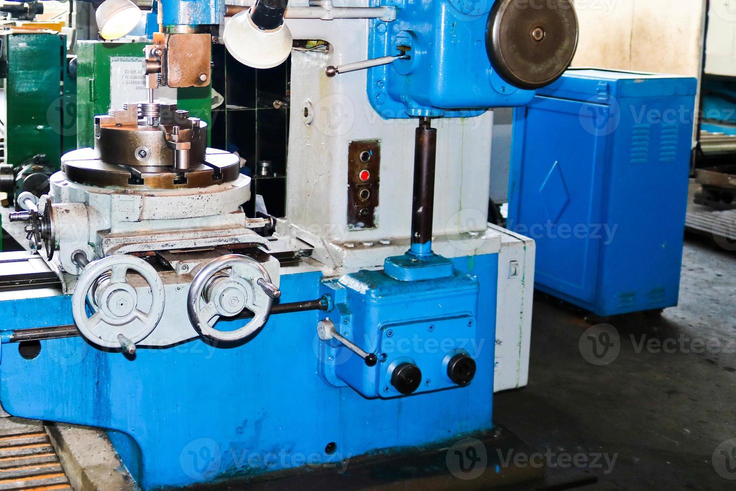 Industrial iron lathe for cutting, turning of billets from metals, wood and other materials, turning, manufacturing of details and spare parts at the factory photo