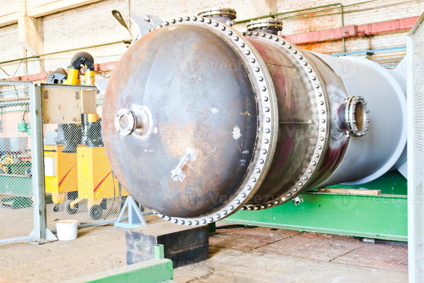 Large metal iron distillation column for separation of substances into fractions in the industrial premises of the shop at an oil refinery, chemical, petrochemical plant photo