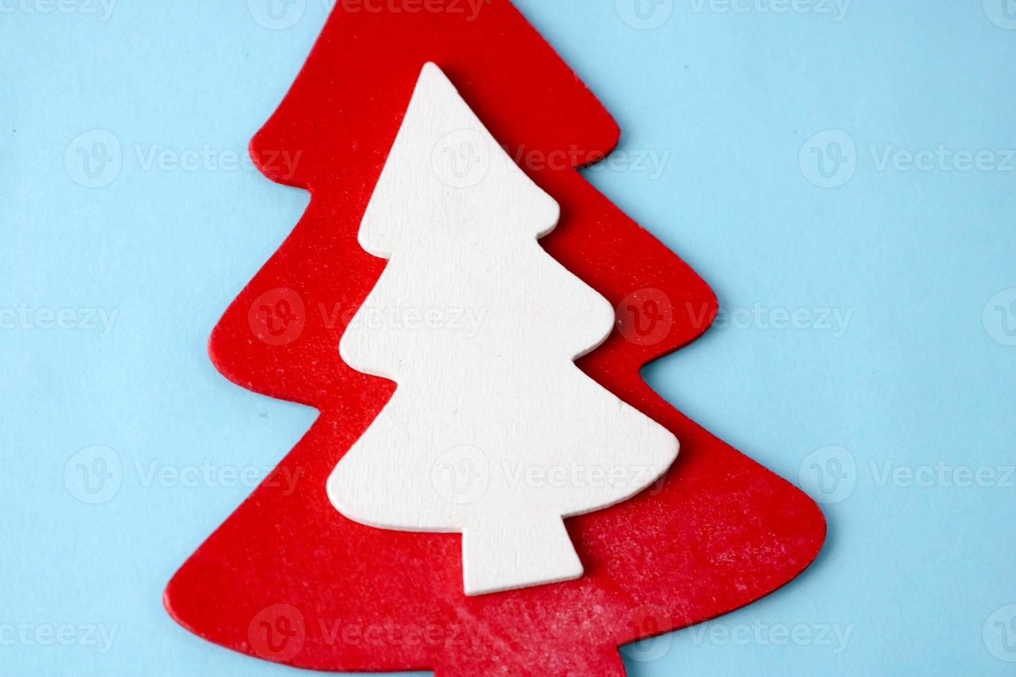 Festive New Year Christmas winter happy light blue beautiful joyful background with a small toy wooden homemade cute Christmas tree. Flat lay. Top view. Holiday decorations photo