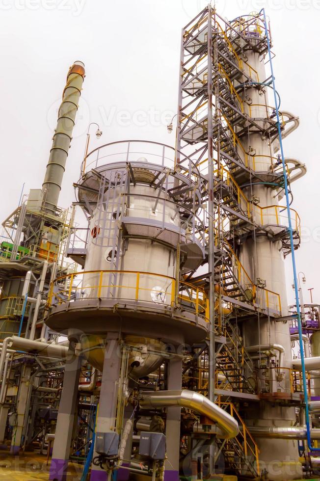 Installation for processing oil with columns and pipes. Refinery. Oil and gas. photo