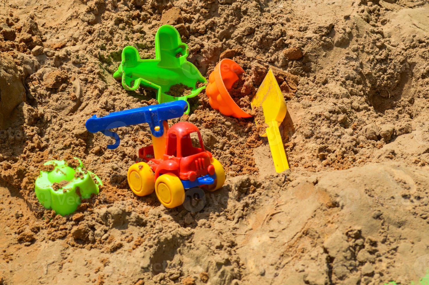 Children's sandbox on the playground for games with toys for children by truck, car, excavator, sand dressers with a spatula photo