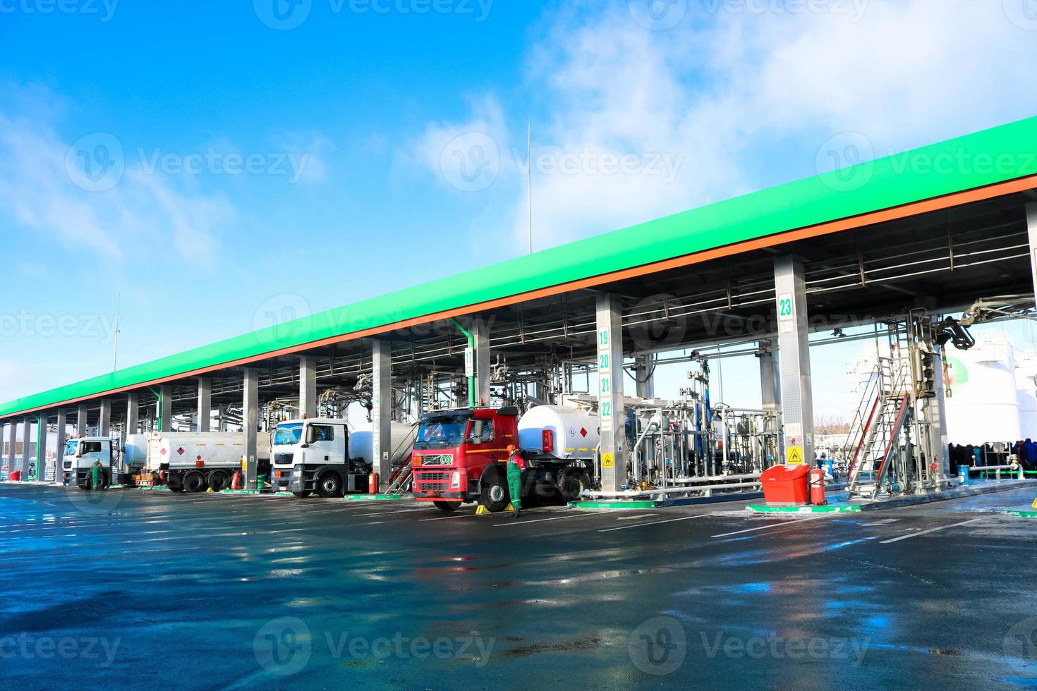 Large green industrial gas station for refueling vehicles, trucks and tanks with fuel, gasoline and diesel in the winter photo