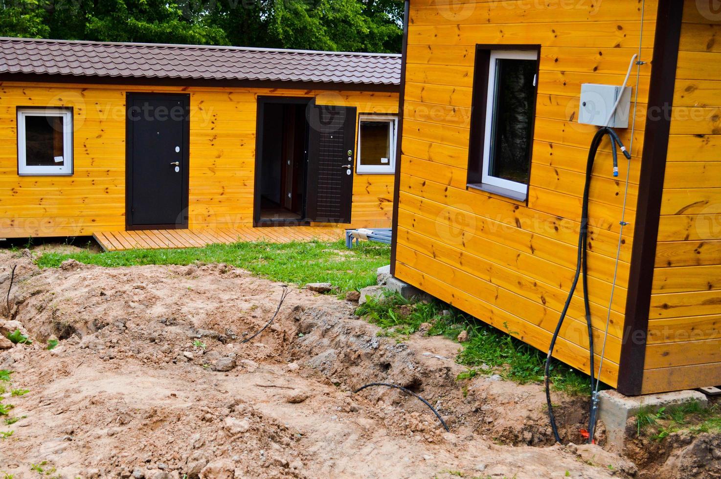 Construction of small yellow wooden frame prefabricated pre-fabricated eco-house of suburban modular fast-growing houses, buildings, cottages. Industrial builde photo