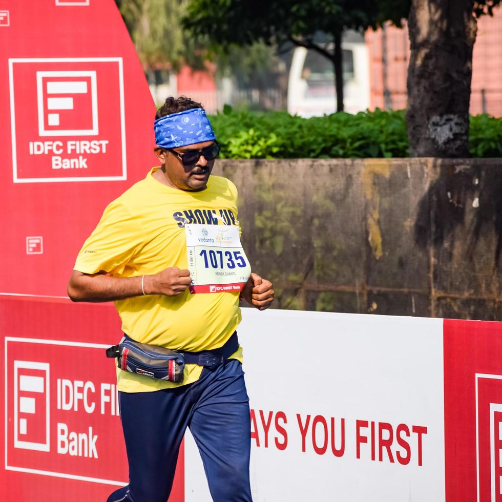 New Delhi, India - October 16 2022 - Vedanta Delhi Half Marathon race after covid in which marathon participants about to cross the finish line, Delhi Half Marathon 2022 photo