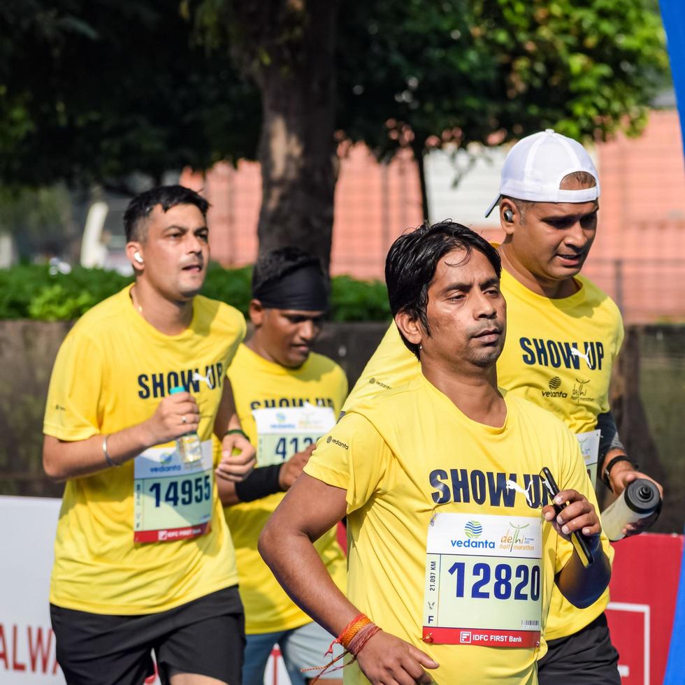 New Delhi, India - October 16 2022 - Vedanta Delhi Half Marathon race after covid in which marathon participants about to cross the finish line, Delhi Half Marathon 2022 photo