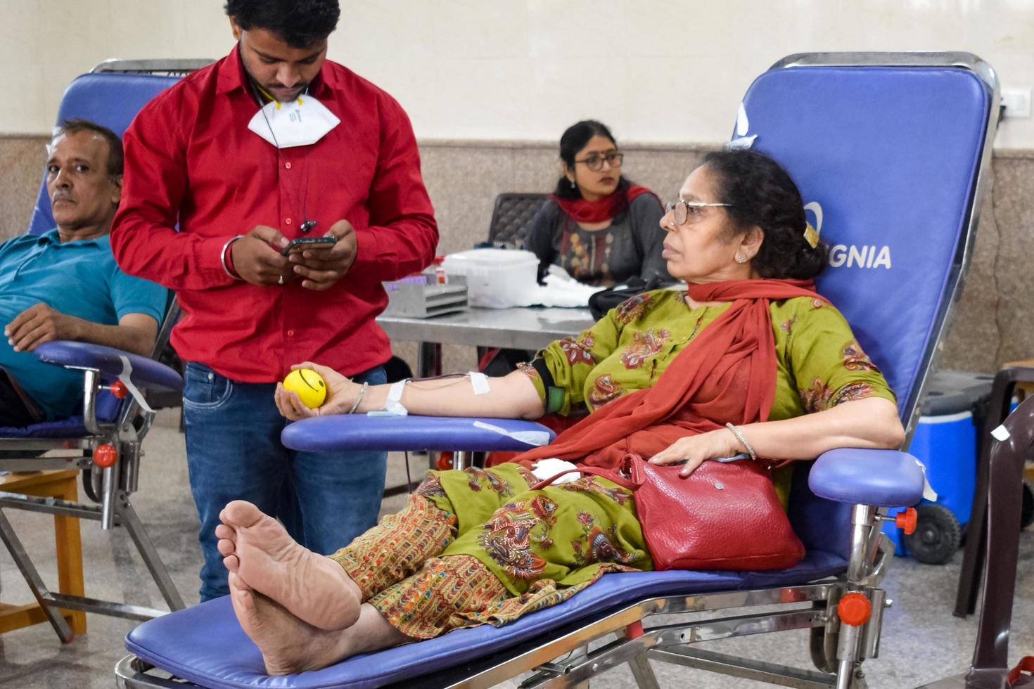 Delhi, India, June 19 2022 - Blood donor at Blood donation camp held at Balaji Temple, Vivek Vihar, Delhi, India, Image for World blood donor day on June 14 every year, Blood Donation Camp at Temple photo
